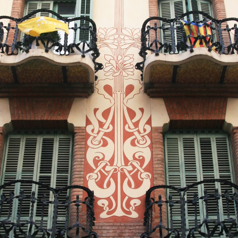 Casa Ramos red and beige sgraffito detail facade